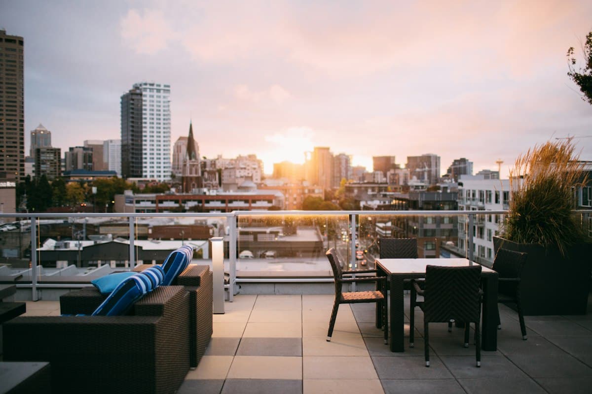 Rooftop terrace at sunset with the city skyline