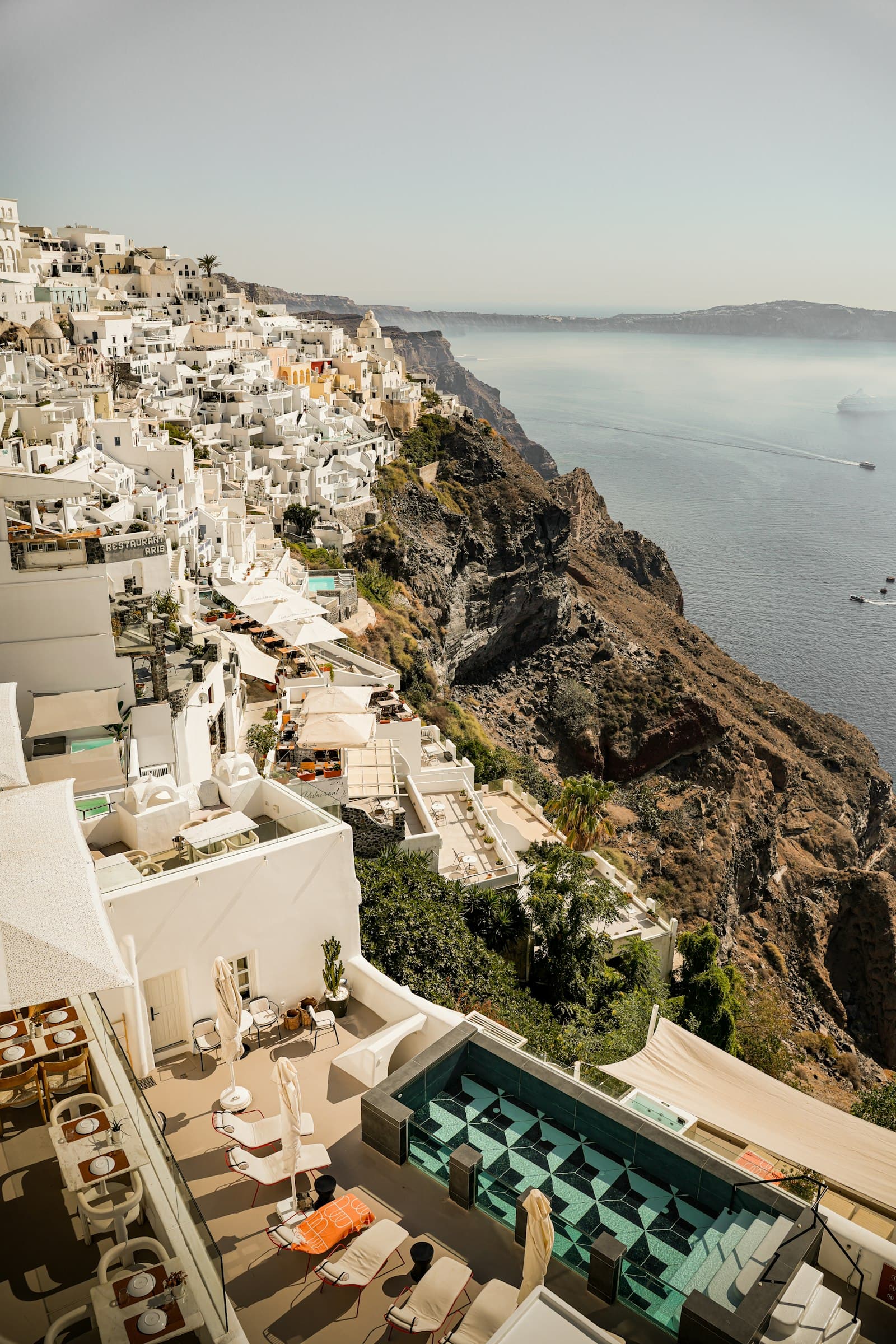 Aerial view of a whitewashed cliffside town overlooking the sea