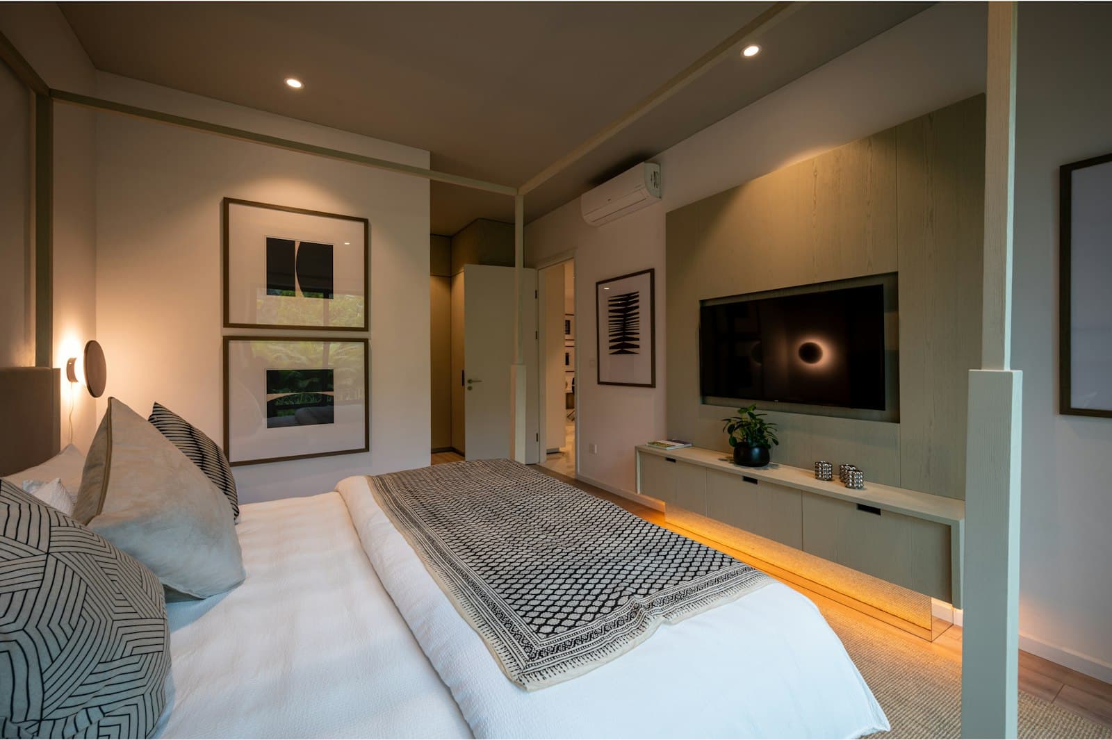 Cozy modern bedroom with artwork and a television