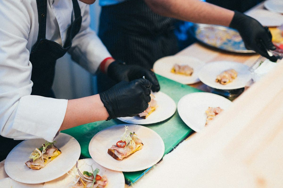 Chefs plating fresh dishes for dinner service