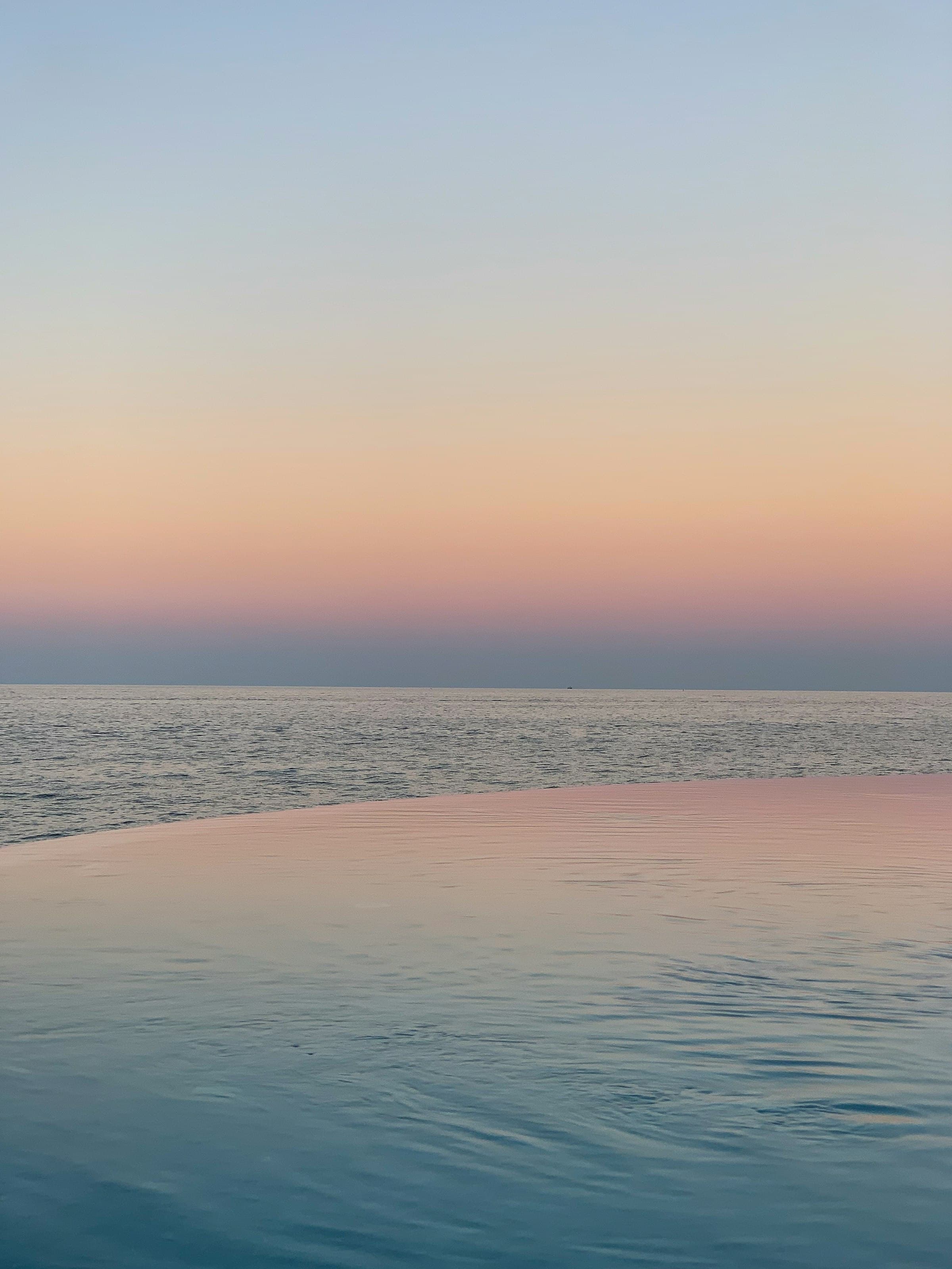 Infinity pool at sunset overlooking the sea