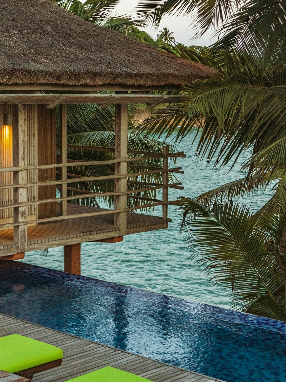 Thatched overwater treehouse bungalow with a private infinity pool